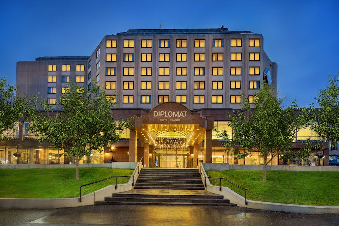 Vienna House Diplomat Hotel — entrance facade at dusk, with the building's lit windows and illuminated DIPLOMAT canopy.